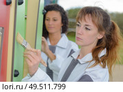 team of women coating a playground feature. Стоковое фото, агентство Ingram Publishing / Фотобанк Лори