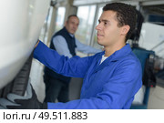 professional industrial engineer adjusting modern machine settings. Стоковое фото, агентство Ingram Publishing / Фотобанк Лори