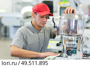 portrait of worker checking a machine. Стоковое фото, агентство Ingram Publishing / Фотобанк Лори