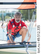 professional waterman training on lake with catamaran. Стоковое фото, агентство Ingram Publishing / Фотобанк Лори