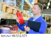 male worker is checking the items. Стоковое фото, агентство Ingram Publishing / Фотобанк Лори