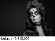 Portrait of a woman with sugar skull makeup over black background. Halloween costume and make-up. Black and white Portrait of Calavera Catrina. Стоковое фото, агентство Ingram Publishing / Фотобанк Лори