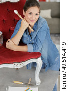 girl artist sitting on chair in sweater and jeans. Стоковое фото, агентство Ingram Publishing / Фотобанк Лори