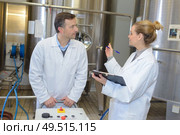 two workers in labcoat working at a factory. Стоковое фото, агентство Ingram Publishing / Фотобанк Лори