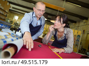 the workers pondering over material. Стоковое фото, агентство Ingram Publishing / Фотобанк Лори