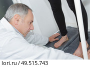podiatrist working with foot. Стоковое фото, агентство Ingram Publishing / Фотобанк Лори