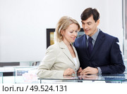 Enamoured couple of middle age in jeweller shop. Стоковое фото, агентство Ingram Publishing / Фотобанк Лори