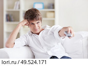 Man changes channels TV remote control. Стоковое фото, агентство Ingram Publishing / Фотобанк Лори