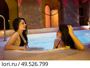 Two women enjoying Arabic baths Hammam in Granada, Andalusia, Spain. Elvira baths. Hot water pool.. Two women enjoying Arabic baths Hammam in Granada. Стоковое фото, агентство Ingram Publishing / Фотобанк Лори