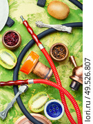 Arabic smoking hookah with taste of kiwi.Fruit shisha tobacco. Tobacco with taste of kiwi.Oriental tobacco hooka. Shisha hookah with kiwi. Стоковое фото, агентство Ingram Publishing / Фотобанк Лори