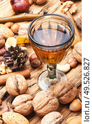 Aromatic alcohol from nuts.Nut liquor.Tincture on nuts.Italian liquor. Autumn nutty liquor. Стоковое фото, агентство Ingram Publishing / Фотобанк Лори