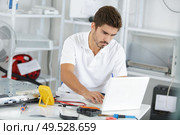 young engineer taking notes while developping new induction hobs. Стоковое фото, агентство Ingram Publishing / Фотобанк Лори