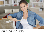 casual woman holding paintbrush by antique chair. Стоковое фото, агентство Ingram Publishing / Фотобанк Лори