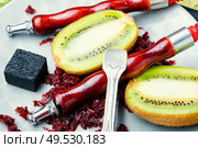 Arabic smoking hookah with taste of kiwi.Fruit shisha tobacco. Tobacco with taste of kiwi.Oriental tobacco hooka. Fragrant smoking hookah with kiwi. Стоковое фото, агентство Ingram Publishing / Фотобанк Лори