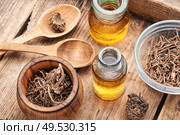 Medicinal tincture from the roots and rhizomes of valerian.Herbal medicine.Healing plants. Healing tincture of valerian. Стоковое фото, агентство Ingram Publishing / Фотобанк Лори