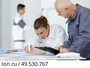 female apprentice with masking tape. Стоковое фото, агентство Ingram Publishing / Фотобанк Лори