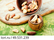 Bertholletia.Peeled brazil nut in wooden mortar.Healthy food. Brazil nut or bertholletia. Стоковое фото, агентство Ingram Publishing / Фотобанк Лори