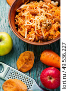 Grated ripe autumn apples in a plate on a wooden old table. Grated ripe apples. Стоковое фото, агентство Ingram Publishing / Фотобанк Лори