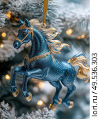 A blue horse ornament with gold accents is hanging from a Christmas tree. Стоковое AI-изображение, AI-художник Ярославский Максим / Фотобанк Лори