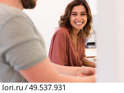 Modern and young couple cooking together at home. Стоковое фото, агентство Ingram Publishing / Фотобанк Лори
