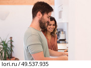 Modern and young couple cooking together at home. Стоковое фото, агентство Ingram Publishing / Фотобанк Лори