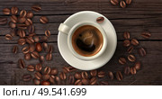 Realistic coffee background with cup of coffee in flatlay style and beans around vector illustration. Стоковая иллюстрация, агентство Ingram Publishing / Фотобанк Лори