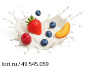 Fresh berries peach slice splashing in creamy milk wave isolated on white background healthy breakfast yogurt ingredients summer dessert concept. Стоковое фото, фотограф Павел Муравьев / Фотобанк Лори