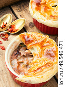 Squid and seafood soup with bread cap.Seafood julienne.. Seafood soup or julienne. Стоковое фото, агентство Ingram Publishing / Фотобанк Лори