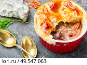 Squid and seafood soup with bread cap.Seafood julienne.. Seafood soup or julienne. Стоковое фото, агентство Ingram Publishing / Фотобанк Лори