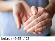 Close Up of a Woman rubbing her hands together with disinfectant . Стоковое фото, агентство Ingram Publishing / Фотобанк Лори