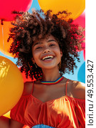 A woman with curly hair joyfully holding a bunch of colorful balloons outdoors. Стоковое AI-изображение, AI-художник Данила Большаков / Фотобанк Лори