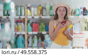 Girl buyer scans qr code on mosquito repellent label. Стоковое видео, видеограф Яков Филимонов / Фотобанк Лори