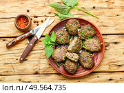 Appetizing homemade nettle meatballs cooked in the oven. Homemade fried cutlets,meatballs. Стоковое фото, агентство Ingram Publishing / Фотобанк Лори