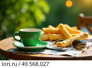 Outdoor table with cheese sticks, a green coffee cup, sunglasses, and orange juice in sunlight, capturing a casual breakfast scene. Ideal for portraying relaxed mornings. Стоковое AI-изображение, AI-художник Анна Маркина / Фотобанк Лори