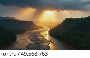 A majestic river flows through green forested hills against a golden sunset landscape with dramatic skies and sunbeams. Стоковое AI-видео, аниматор Анжелика Самсонова / Фотобанк Лори