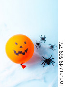 Halloween scene with scary balloon and spiders in web on blue background. Halloween scene with balloons. Стоковое фото, агентство Ingram Publishing / Фотобанк Лори