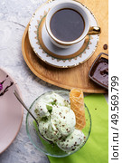 porcelain cup of coffee with pistachio ice cream  served  at table. life style concept. Стоковое фото, агентство Ingram Publishing / Фотобанк Лори