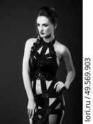 white girl modell on a dark background in a dress made of cut stripes of black fabric. Стоковое фото, агентство Ingram Publishing / Фотобанк Лори