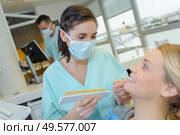 dentist curing a woman patient in the dental office. Стоковое фото, агентство Ingram Publishing / Фотобанк Лори