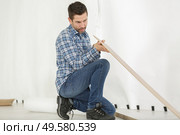 man installing new laminated wooden floor close up. Стоковое фото, агентство Ingram Publishing / Фотобанк Лори