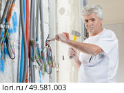 a builder is chiseling wall. Стоковое фото, агентство Ingram Publishing / Фотобанк Лори