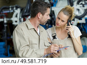 woman on the phone next to colleague in a factory. Стоковое фото, агентство Ingram Publishing / Фотобанк Лори