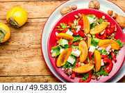 Fresh fruit salad with persimmons and cheese. Salad with persimmon. Стоковое фото, агентство Ingram Publishing / Фотобанк Лори