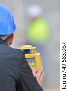 Rear view of surveyor using theodolite. Стоковое фото, агентство Ingram Publishing / Фотобанк Лори