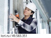 woman drilling with electric power driller. Стоковое фото, агентство Ingram Publishing / Фотобанк Лори
