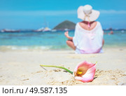 Calm woman meditating on a beach, beautiful flower. Стоковое фото, агентство Ingram Publishing / Фотобанк Лори