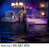 Portrait of a beautiful woman in a conceptual flooded apartment. Стоковое фото, агентство Ingram Publishing / Фотобанк Лори