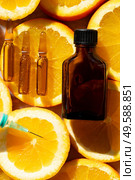 Citrus fruit vitamin c serum oil beauty care in ampullas and bottle close up, anti aging natural cosmetic.. Citrus fruit vitamin c serum oil beauty care. Стоковое фото, агентство Ingram Publishing / Фотобанк Лори