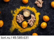 Curcuma (turmeric) spice , ginger, lemon and honey  served at black table. Cuisine ingredients. healthy concept.  flat lay. Стоковое фото, агентство Ingram Publishing / Фотобанк Лори