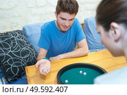 couple in love playing ludo board game. Стоковое фото, агентство Ingram Publishing / Фотобанк Лори
